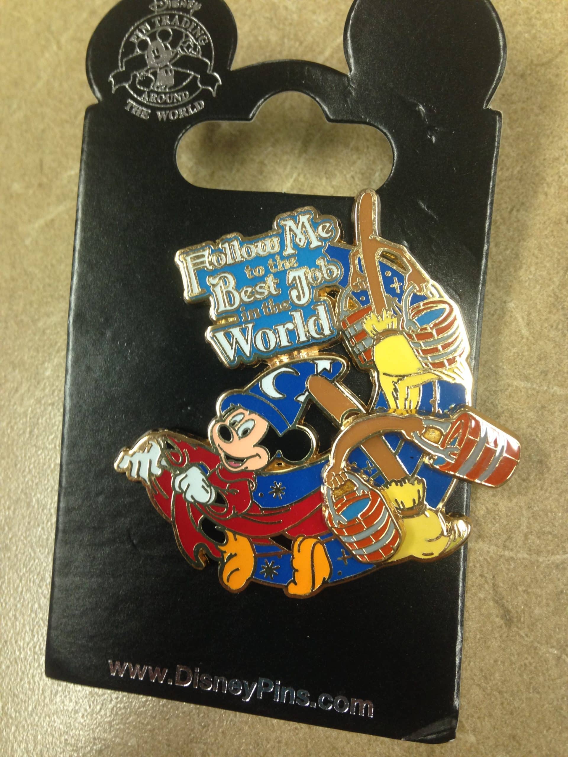 Disney trading pin with Sorcerer Mickey and brooms with buckets that says "Follow me to the best job in the world"